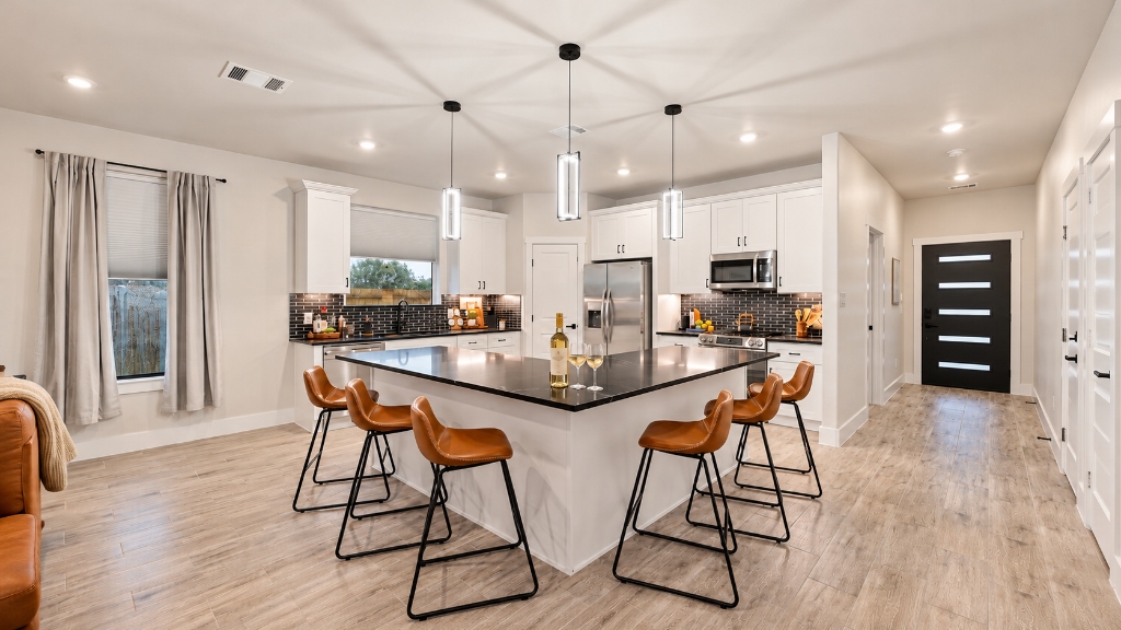 Gourmet Kitchen with Expansive Black Island & Leather Barstools